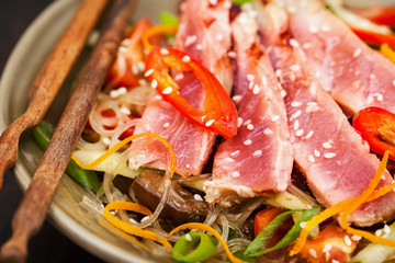 Grilled tuna and  asian rice glass noodles with vegetables
