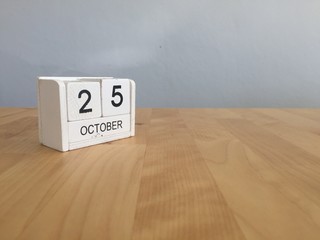 October 25th.October 25 white wooden calendar on vintage wood ab