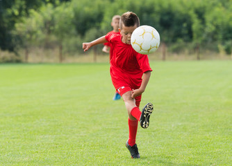 Obraz premium Boy Shooting at Goal