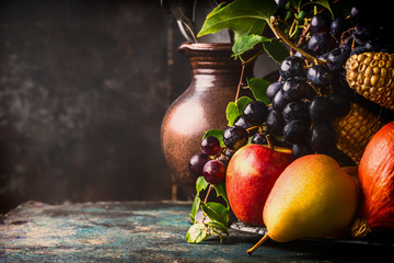 Autumn harvest concept. Fall fruits and vegetables on dark rustic kitchen table at wooden background, side view,copy space, close up