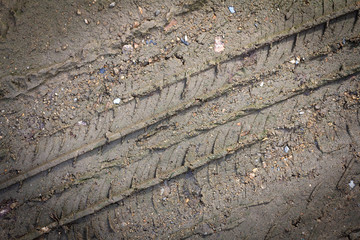 Wheel track on the soil. Track wheel on the ground. Dark edged.