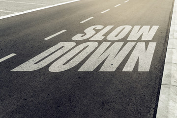 Slow down speed limit sign on highway - obrazy, fototapety, plakaty