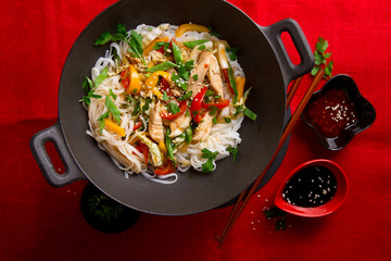 Asian rice noodles wok with chicken and vegetables