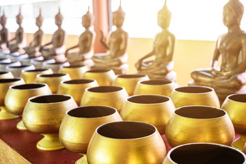 monk's alms bowl and buddha statue for largess in temple