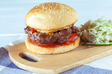 home made burgers on wooden background