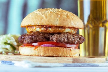 home made burgers on wooden background