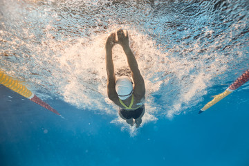 Swimmer in back crawl style underwater