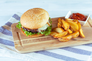 burger and french fries on wooden table