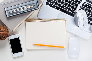 White office desk table with a lot of things on it. Top view