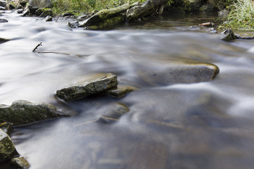 Fototapeta na wymiar Flowing water among the rocks.