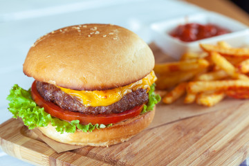burger and french fries on wooden table