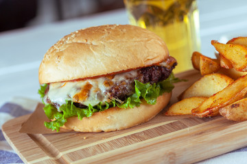 burger and french fries on wooden table
