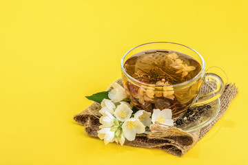 Cup of green tea with jasmine flowers with copy space