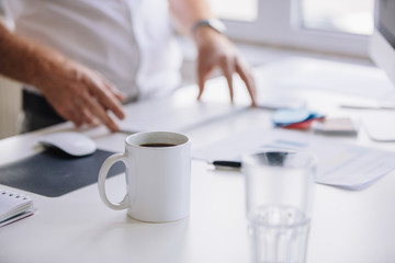 Cup of fresh coffee on work desk