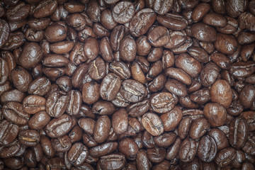 Coffee beans closeup. Roasted brown coffee beans texture or coffee beans background for design.