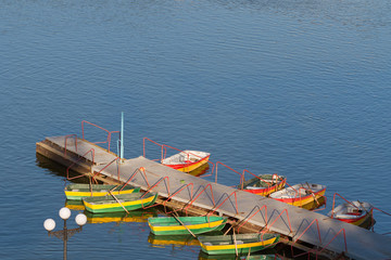 Fototapeta na wymiar Boat rental station with colorful empty boats