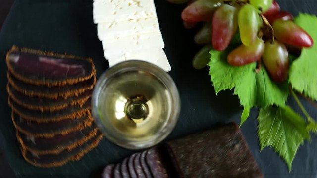 wine grapes cheese jerky basturma on black stone
