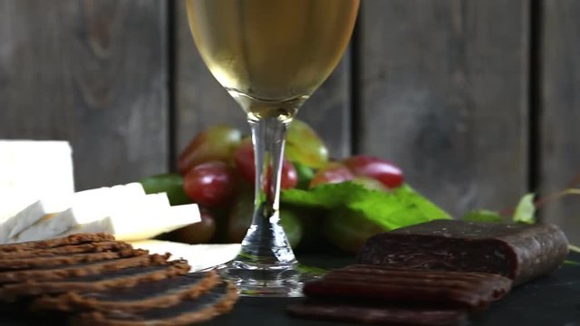 wine grapes cheese jerky basturma on black stone