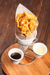 Breaded chicken pieces in a paper bag