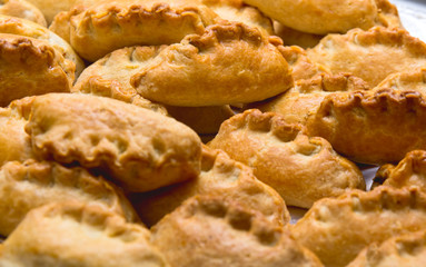 a few small fresh pies with golden crust.
