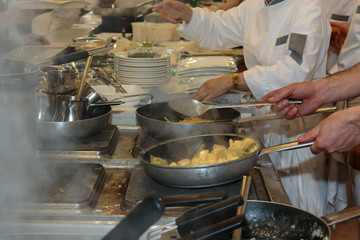 Cooking inside Restaurant's Kitchen, Pans and Chef with Uniform