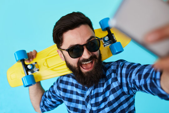 young bearded hipster man makes a selfie