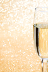 Champagne glass cup on brilliant golden background

