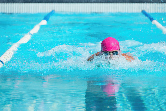 Action shot swimmer swimming breaststroke in the pool