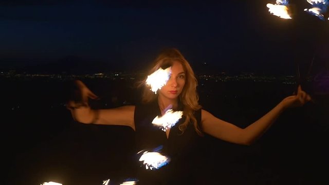 Young blonde woman with flaming torches
