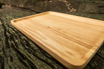 Empty wooden plate on wood table with copy space.