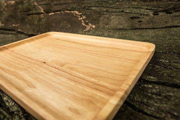 Empty wooden plate on wood table with copy space.