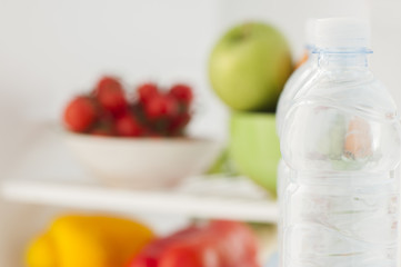 Bottles with water in refrigerator