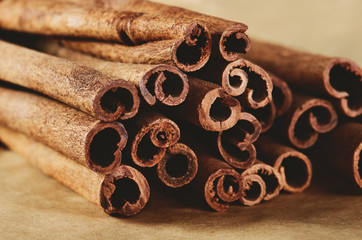 cinnamon sticks on paper background close-up horizontal