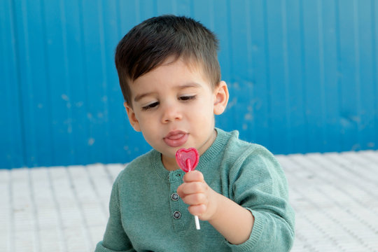 Happy Kid Eating A Lollipop