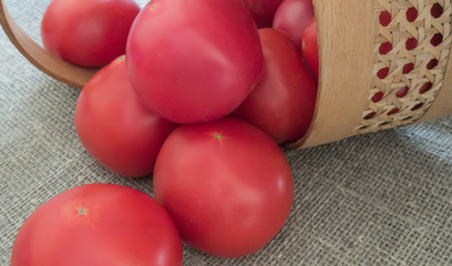 Red tomatoes in basket, closeup