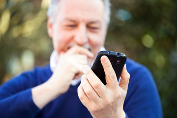 Mature man using a mobile phone