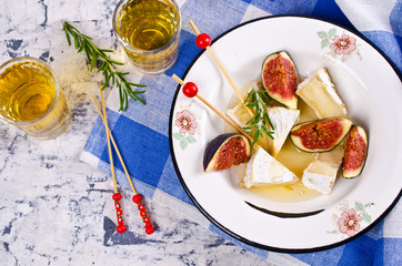 Pieces of Camembert and figs