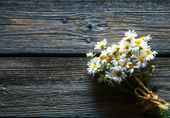 Obraz premium Bouquet of daisy flowers on a wooden background