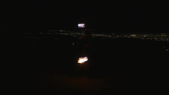 Fireshow performance with burning torch at night