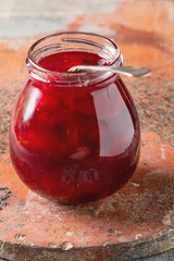 Homemade jam of plums with cinnamon and fresh fruits on wooden b