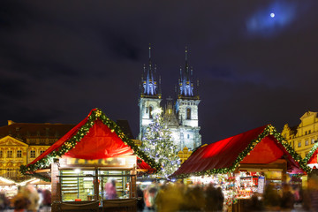 Old Town Square with Christmas tree and fairy tale Church of our Lady Tyn in the magical city of Prague at night, Czech Republic