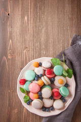 Traditional French sweets. Assorted colorful macaroons with mint