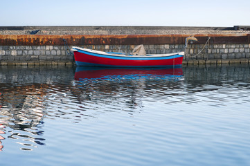 Fototapeta na wymiar A rowboat moored in the dockside