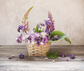 still life with summer flowers in basket