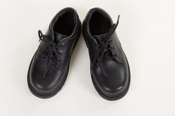 Black leather shoes for the little boy.
