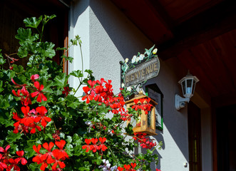 Fototapeta na wymiar Beautiful guesthouse with terrace in Alsace, France. Alpine styl