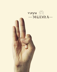 Image of woman hand in Vayu mudra. Gesture is  isolated on toned background.