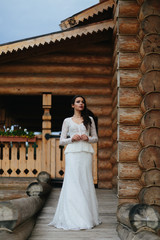 Woman in an old-fashioned dress waits for someone standing behin