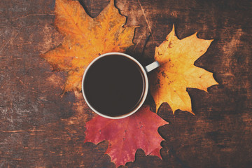 Autumn Fall Background  with maple leaves and cup of black coffe