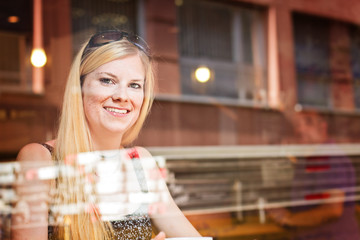 Woman with cup of coffee sitting at the cafe